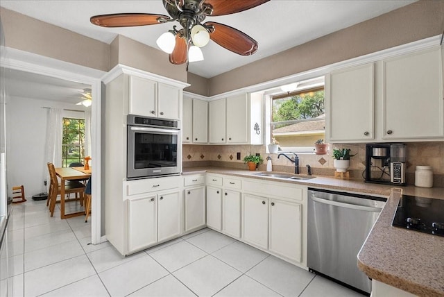 431 Shadow Creek Dr, El Lago, TX 77586 - kitchen featuring appliances with stainless steel finishes, a ceiling fan, plenty of natural light, and backsplash
