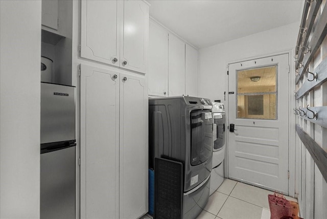 431 Shadow Creek Dr, El Lago, TX 77586 - laundry room with cabinet space, washing machine and clothes dryer, and light tile patterned floors