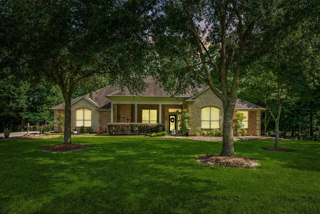 1114 Commons Waterway Dr, Huffman, TX 77336 - single story home featuring a front yard and stone siding