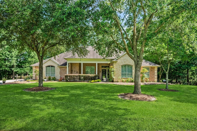 1114 Commons Waterway Dr, Huffman, TX 77336 - ranch-style house with a front lawn, brick siding, and roof with shingles