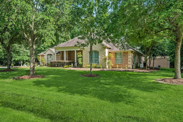 1114 Commons Waterway Dr, Huffman, TX 77336 - view of front of property with a front lawn, brick siding, and a shingled roof