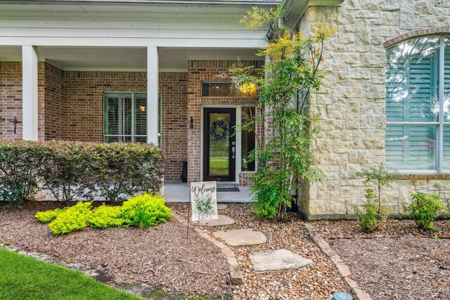 1114 Commons Waterway Dr, Huffman, TX 77336 - property entrance featuring covered porch, stone siding, and brick siding