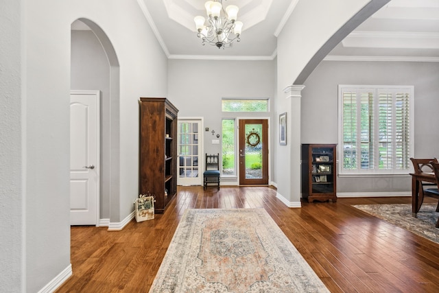 1114 Commons Waterway Dr, Huffman, TX 77336 - foyer featuring arched walkways, hardwood / wood-style flooring, a chandelier, ornamental molding, and a towering ceiling