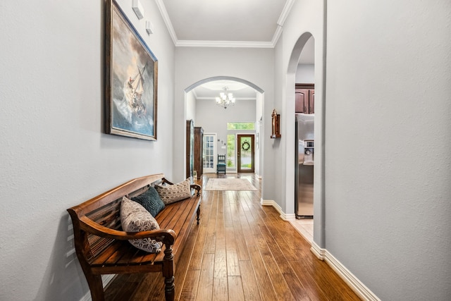 1114 Commons Waterway Dr, Huffman, TX 77336 - hall with arched walkways, hardwood / wood-style floors, a chandelier, and crown molding