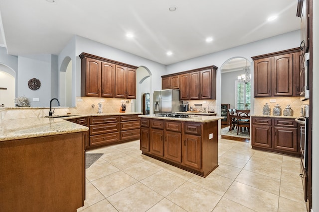 1114 Commons Waterway Dr, Huffman, TX 77336 - kitchen featuring arched walkways, tasteful backsplash, appliances with stainless steel finishes, and recessed lighting