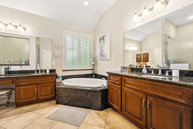 1114 Commons Waterway Dr, Huffman, TX 77336 - bathroom featuring lofted ceiling, a shower stall, two vanities, tile patterned floors, and a garden tub