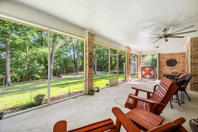 1114 Commons Waterway Dr, Huffman, TX 77336 - sunroom / solarium featuring a ceiling fan and view of scattered trees