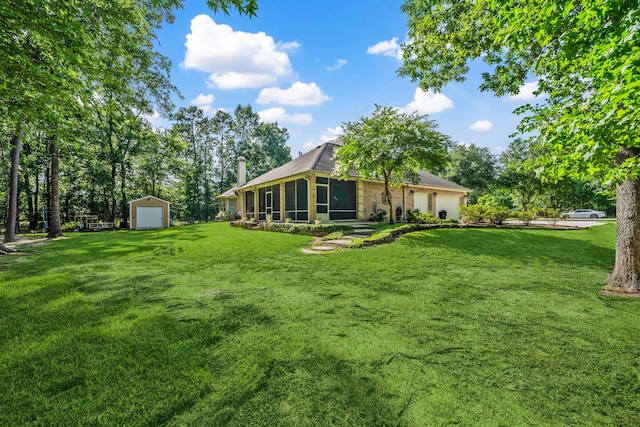 1114 Commons Waterway Dr, Huffman, TX 77336 - view of green lawn with an outbuilding, a garage, and a sunroom
