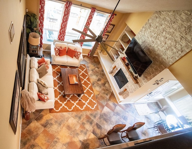 9430 Oratorio Ct, Houston, TX 77040 - living room with a ceiling fan, stone finish flooring, and a fireplace