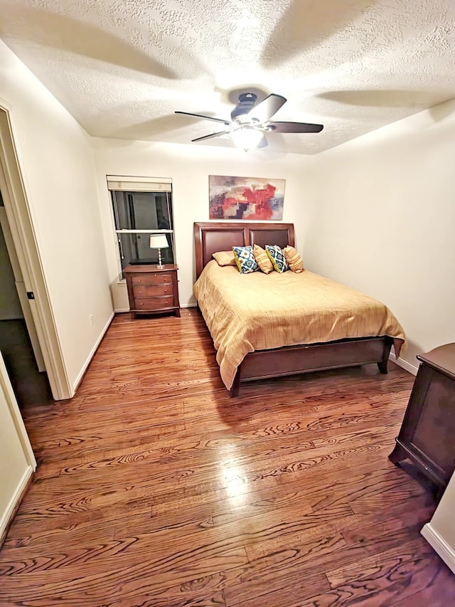 9430 Oratorio Ct, Houston, TX 77040 - bedroom with a textured ceiling, wood finished floors, and ceiling fan