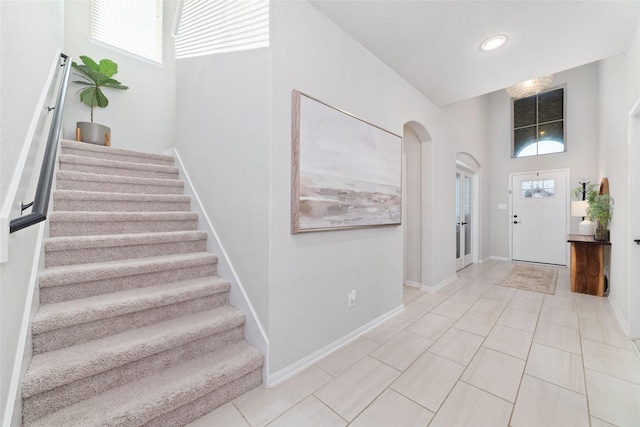 18534 Tall Woods Pl, Houston, TX 77084 - entryway featuring stairway, arched walkways, light tile patterned floors, and recessed lighting