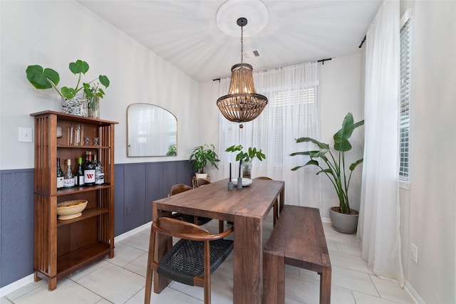 18534 Tall Woods Pl, Houston, TX 77084 - dining room with light tile patterned floors, a chandelier, and wainscoting