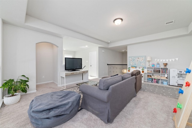 18534 Tall Woods Pl, Houston, TX 77084 - living room with a tray ceiling, arched walkways, and carpet