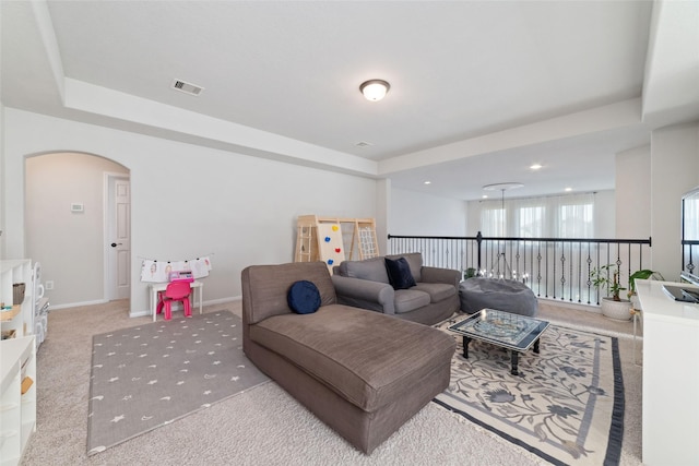 18534 Tall Woods Pl, Houston, TX 77084 - living area featuring carpet flooring, arched walkways, a raised ceiling, and recessed lighting