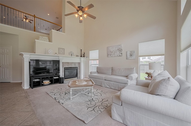 15902 Mill Canyon Ct, Cypress, TX 77429 - living area with a high ceiling, a ceiling fan, a tiled fireplace, and healthy amount of natural light