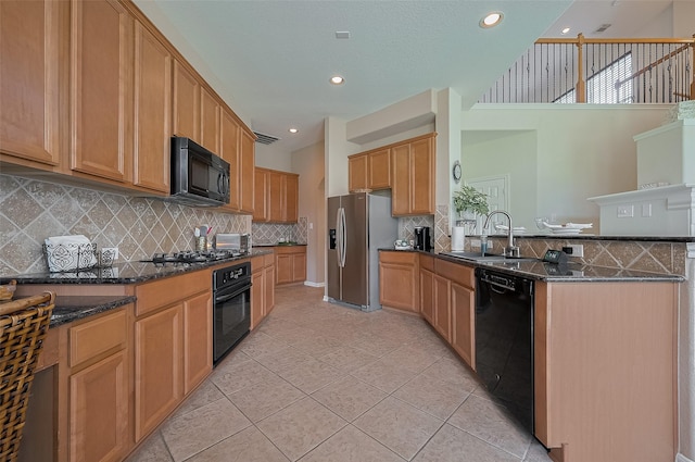 15902 Mill Canyon Ct, Cypress, TX 77429 - kitchen featuring black appliances, a peninsula, light tile patterned floors, dark stone countertops, and recessed lighting