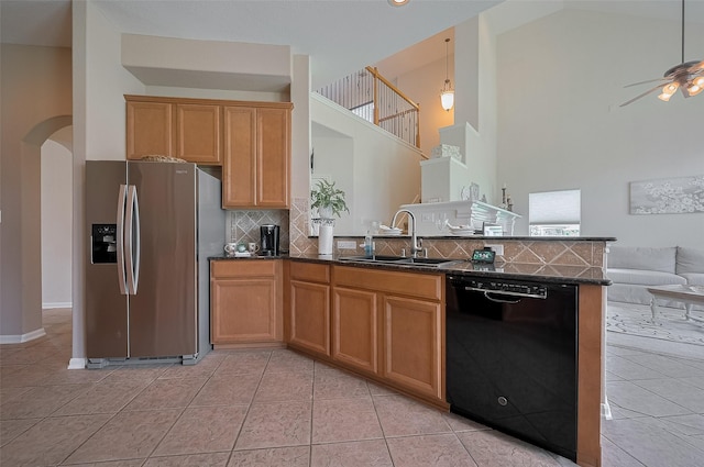 15902 Mill Canyon Ct, Cypress, TX 77429 - kitchen featuring black dishwasher, stainless steel fridge, open floor plan, light tile patterned floors, and a high ceiling
