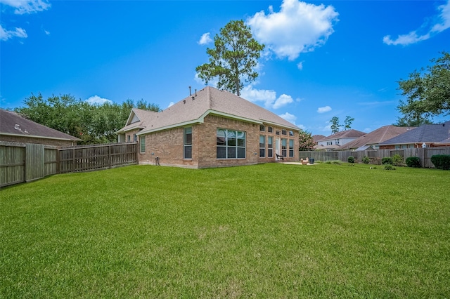 15902 Mill Canyon Ct, Cypress, TX 77429 - back of property featuring a fenced backyard, brick siding, and a shingled roof