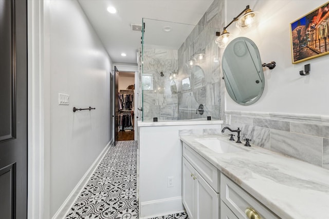 1212 Bingham St, Houston, TX 77007 - bathroom featuring vanity, a tile shower, a spacious closet, recessed lighting, and tile patterned floors