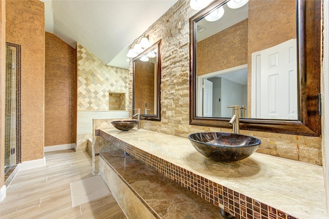 13727 Sablegarden Ln, Houston, TX 77014 - full bath with double vanity, lofted ceiling, wood finished floors, and tasteful backsplash