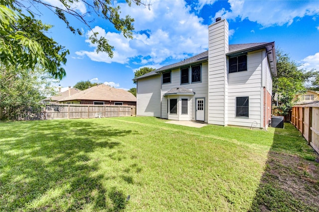 13727 Sablegarden Ln, Houston, TX 77014 - rear view of property with a fenced backyard, a chimney, a patio, and a shingled roof