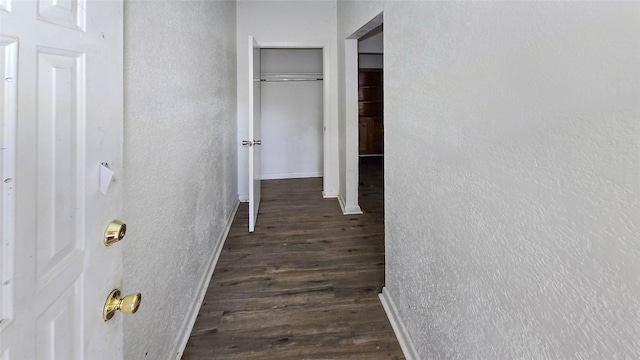 242 Bishop, Livingston, TX 77351 - corridor with a textured wall and dark wood finished floors