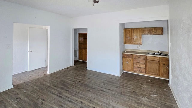 242 Bishop, Livingston, TX 77351 - kitchen with brown cabinetry, dark wood-style floors, light countertops, and a ceiling fan