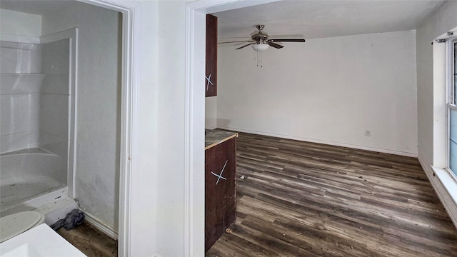 242 Bishop, Livingston, TX 77351 - unfurnished living room featuring ceiling fan and dark wood-style floors