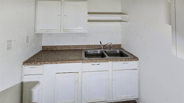 242 Bishop, Livingston, TX 77351 - kitchen with white cabinets and dark countertops