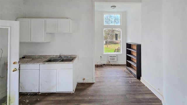 242 Bishop, Livingston, TX 77351 - kitchen featuring dark wood-style flooring and white cabinetry