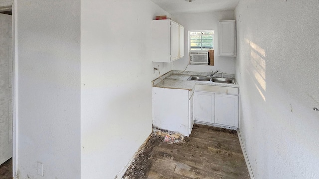 242 Bishop, Livingston, TX 77351 - kitchen with white cabinetry, light countertops, dark wood-style floors, and cooling unit