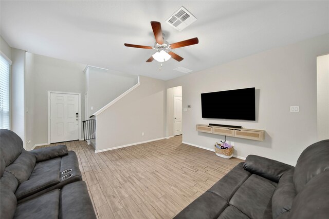 24715 Winema Woods Ln, Huffman, TX 77336 - living room with ceiling fan, wood finished floors, and stairs