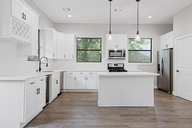 806 E 39th St Unit A, Houston, TX 77022 - kitchen featuring stainless steel appliances, plenty of natural light, tasteful backsplash, a kitchen island, and recessed lighting