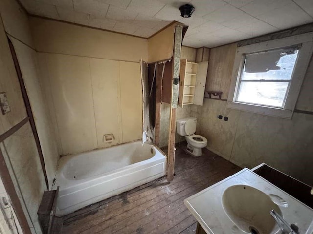 509 N Waggoner St, Electra, TX 76360 - bathroom with hardwood / wood-style floors, vanity, and shower / bathtub combination