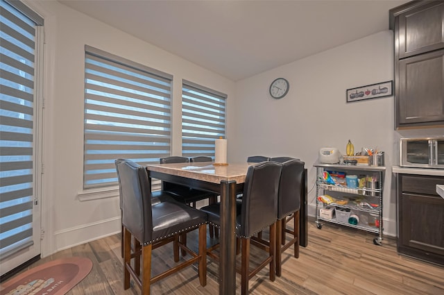 9011 Bright Harbor Dr, Cypress, TX 77433 - dining room with light wood finished floors and baseboards