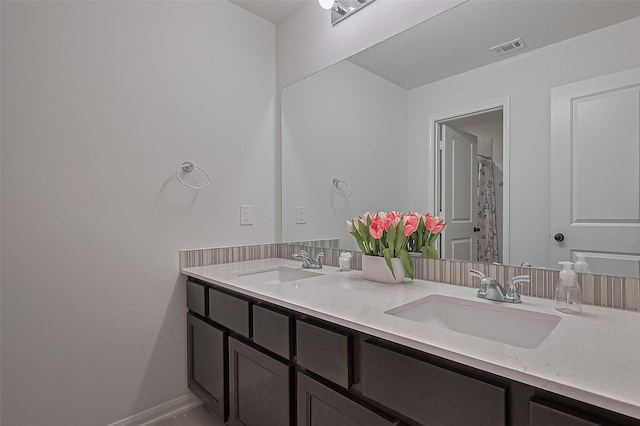9011 Bright Harbor Dr, Cypress, TX 77433 - bathroom featuring double vanity and baseboards