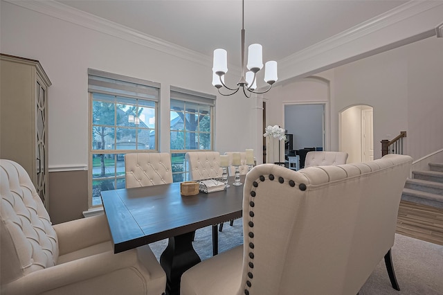 9011 Bright Harbor Dr, Cypress, TX 77433 - dining room featuring crown molding, a chandelier, arched walkways, stairs, and carpet floors