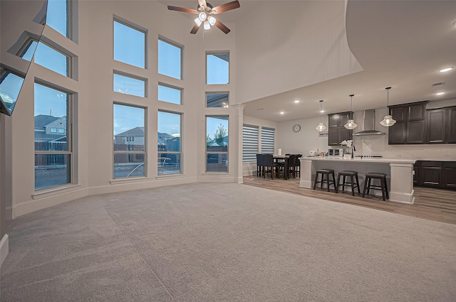 9011 Bright Harbor Dr, Cypress, TX 77433 - living area featuring ceiling fan, healthy amount of natural light, recessed lighting, light colored carpet, and a high ceiling