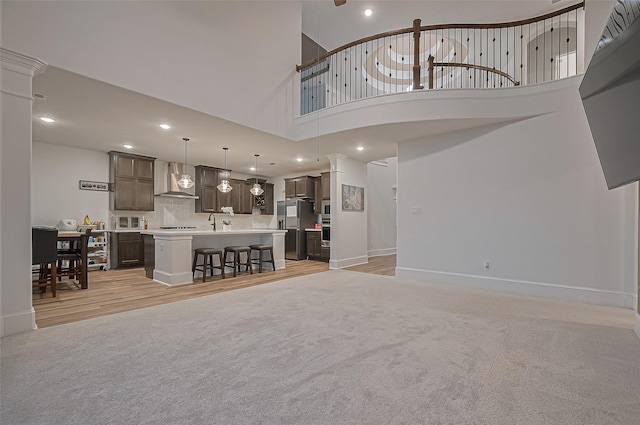 9011 Bright Harbor Dr, Cypress, TX 77433 - living room with recessed lighting, light carpet, light wood-style floors, and a towering ceiling