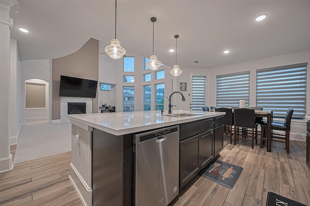 9011 Bright Harbor Dr, Cypress, TX 77433 - kitchen featuring dishwasher, light countertops, light wood-style flooring, a fireplace, and recessed lighting