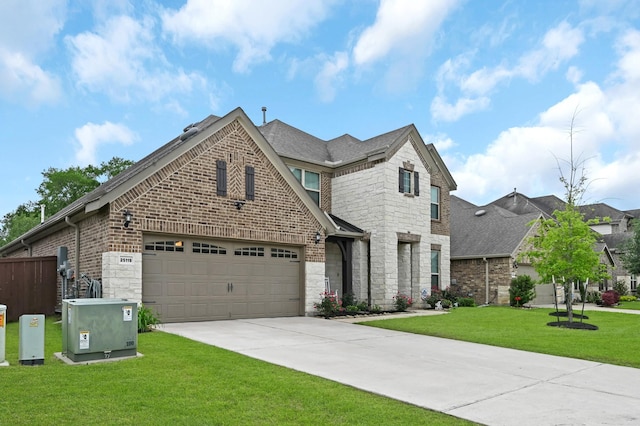25119 Dunbrook Springs Ln, Katy, TX 77494 - view of front facade with brick siding, a garage, concrete driveway, stone siding, and a shingled roof