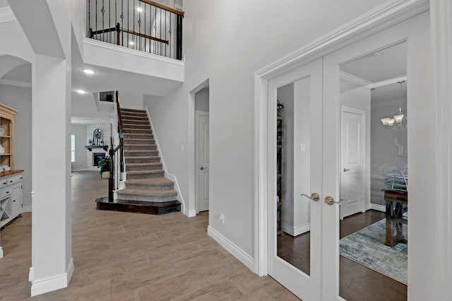 25119 Dunbrook Springs Ln, Katy, TX 77494 - foyer entrance with light wood-style flooring, arched walkways, stairs, french doors, and ornamental molding