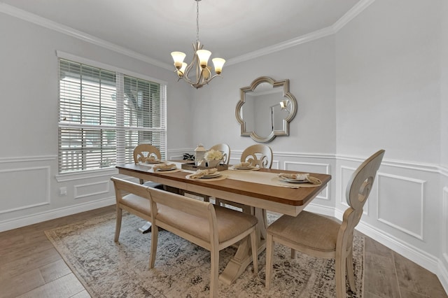 25119 Dunbrook Springs Ln, Katy, TX 77494 - dining room featuring a chandelier, ornamental molding, a decorative wall, wood finished floors, and a wainscoted wall