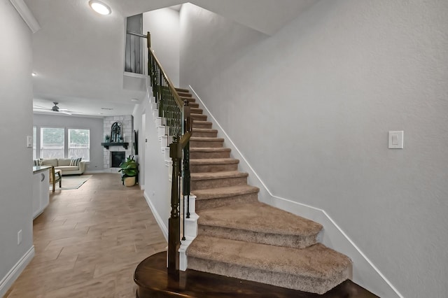 25119 Dunbrook Springs Ln, Katy, TX 77494 - staircase featuring a fireplace and a ceiling fan