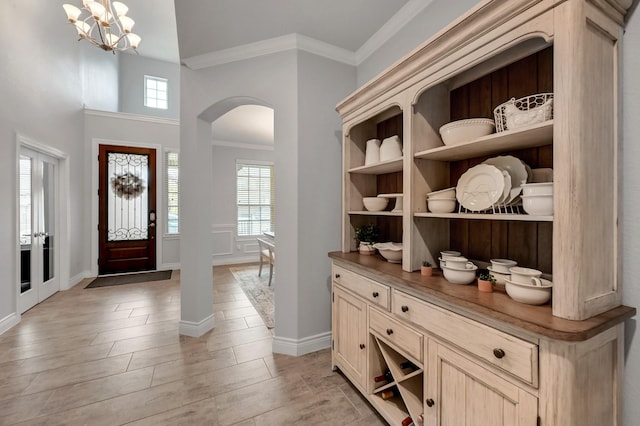 25119 Dunbrook Springs Ln, Katy, TX 77494 - entryway with arched walkways, ornamental molding, healthy amount of natural light, light wood-style floors, and a chandelier