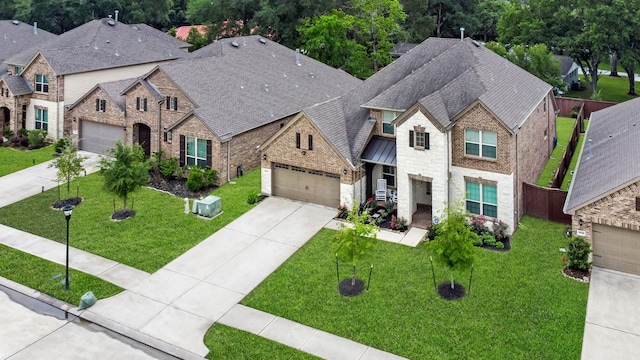 25119 Dunbrook Springs Ln, Katy, TX 77494 - french country home featuring driveway, stone siding, brick siding, a standing seam roof, and roof with shingles