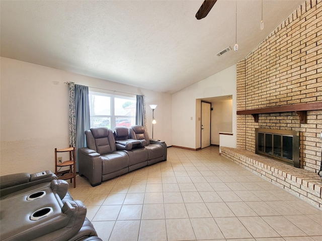 17602 Kakerglen Ct, Houston, TX 77084 - living area featuring vaulted ceiling, ceiling fan, a textured ceiling, light tile patterned flooring, and a fireplace