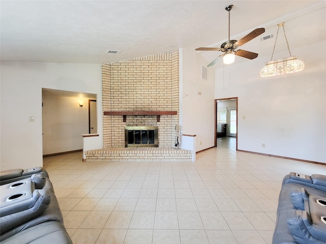 17602 Kakerglen Ct, Houston, TX 77084 - unfurnished living room with a ceiling fan, a brick fireplace, light tile patterned flooring, and high vaulted ceiling