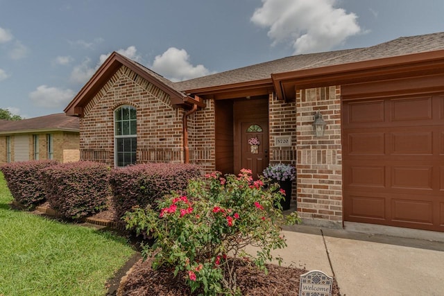 5720 Sunbird Ln, Beaumont, TX 77708 - view of front of house featuring brick siding, a garage, and roof with shingles