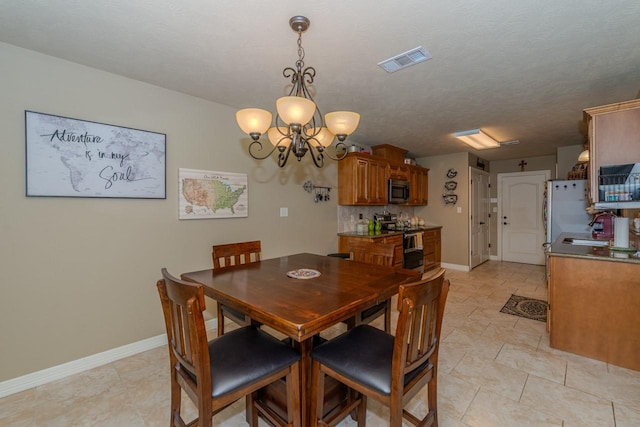 5720 Sunbird Ln, Beaumont, TX 77708 - dining area featuring a chandelier and baseboards